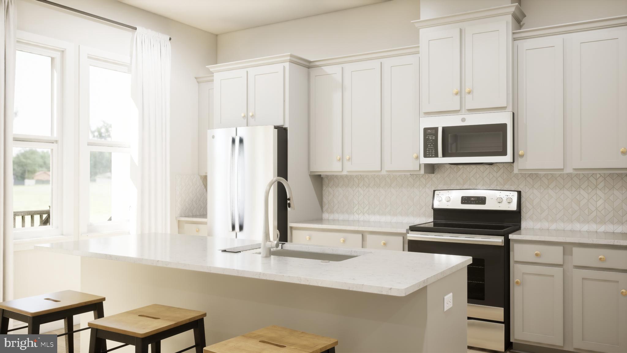 a kitchen with stainless steel appliances a stove a sink and white cabinets