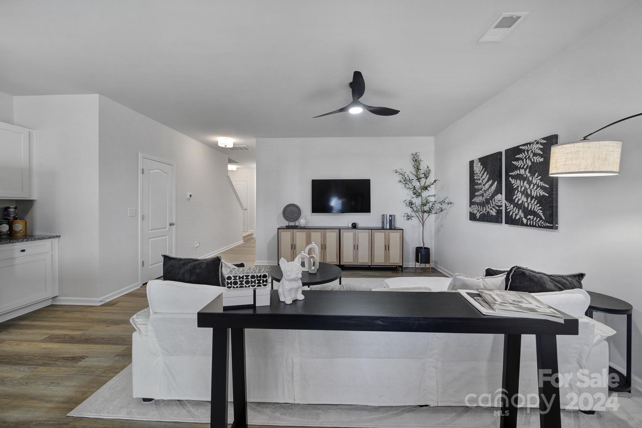 a living room with furniture and a flat screen tv