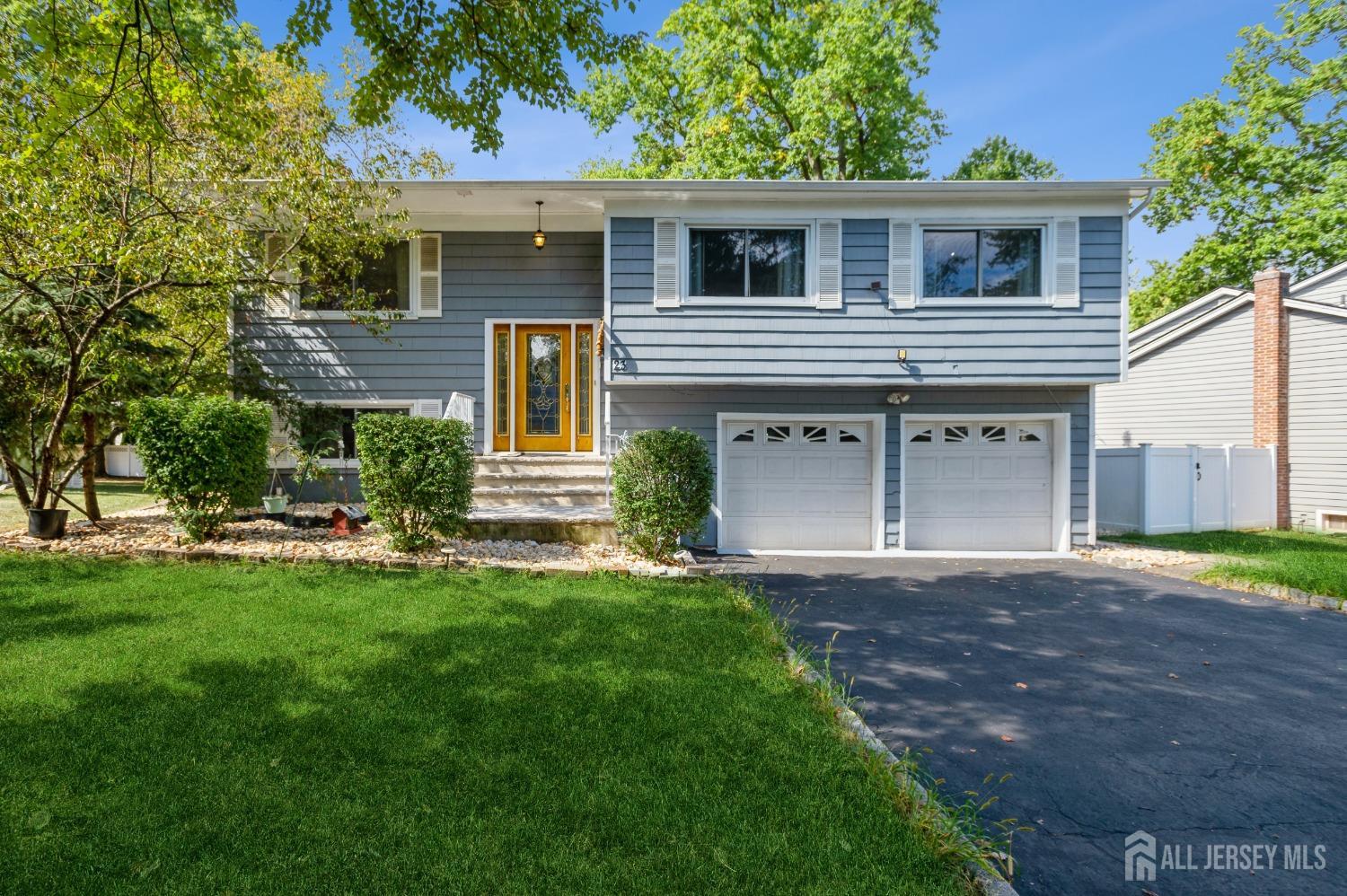 a front view of a house with a garden and yard