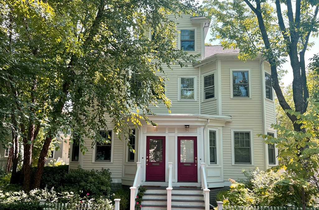 front view of a house with a tree