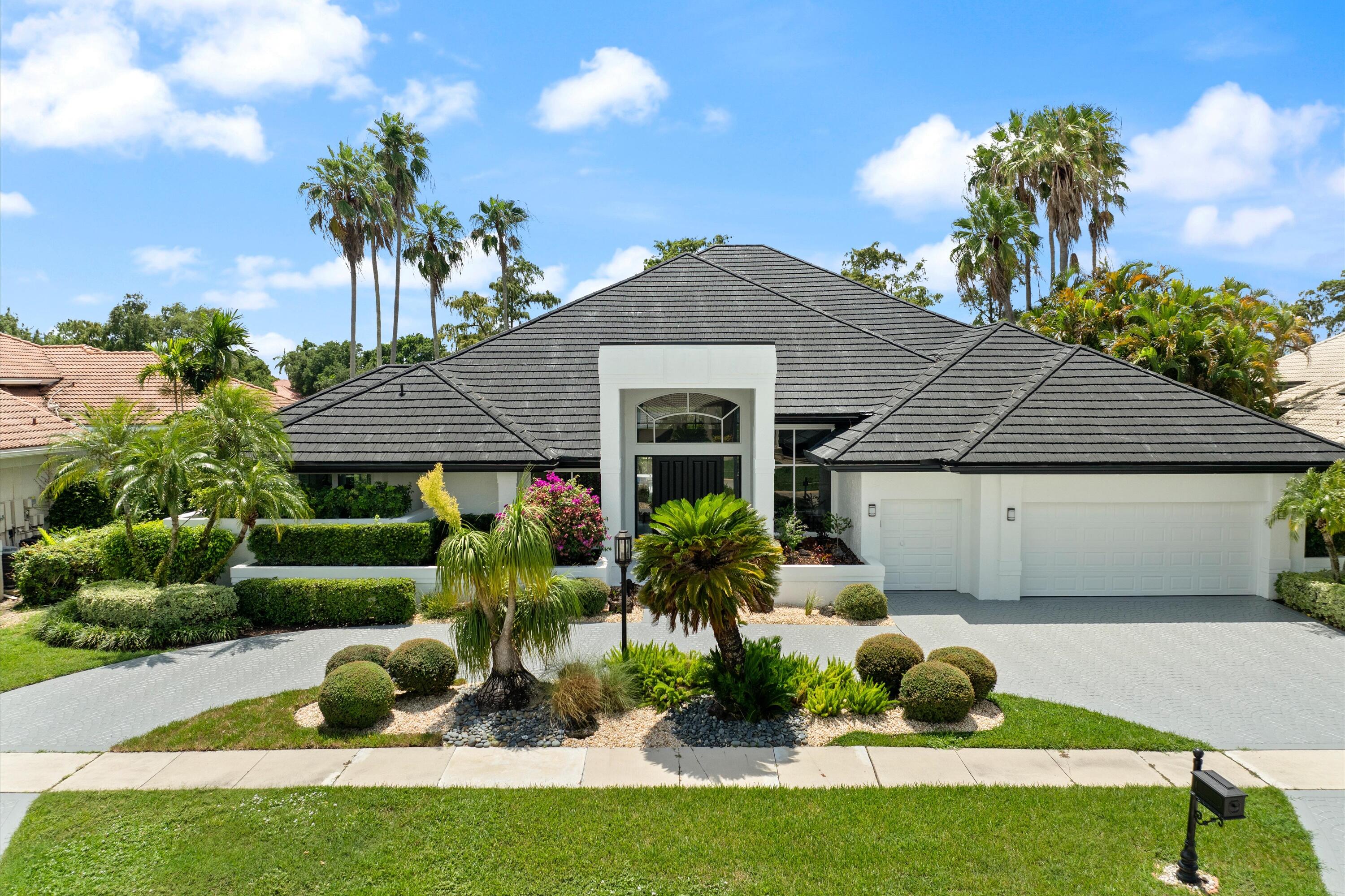 a front view of house with a garden