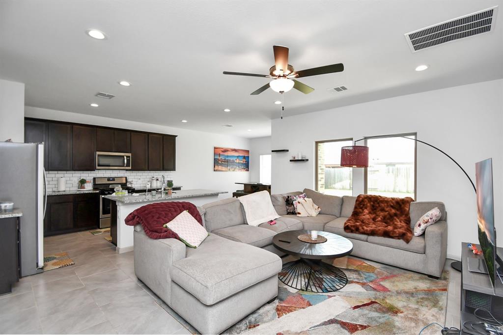 a living room with furniture a rug and a chandelier