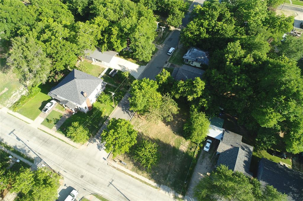 an aerial view of a house with a yard basket ball court and outdoor seating