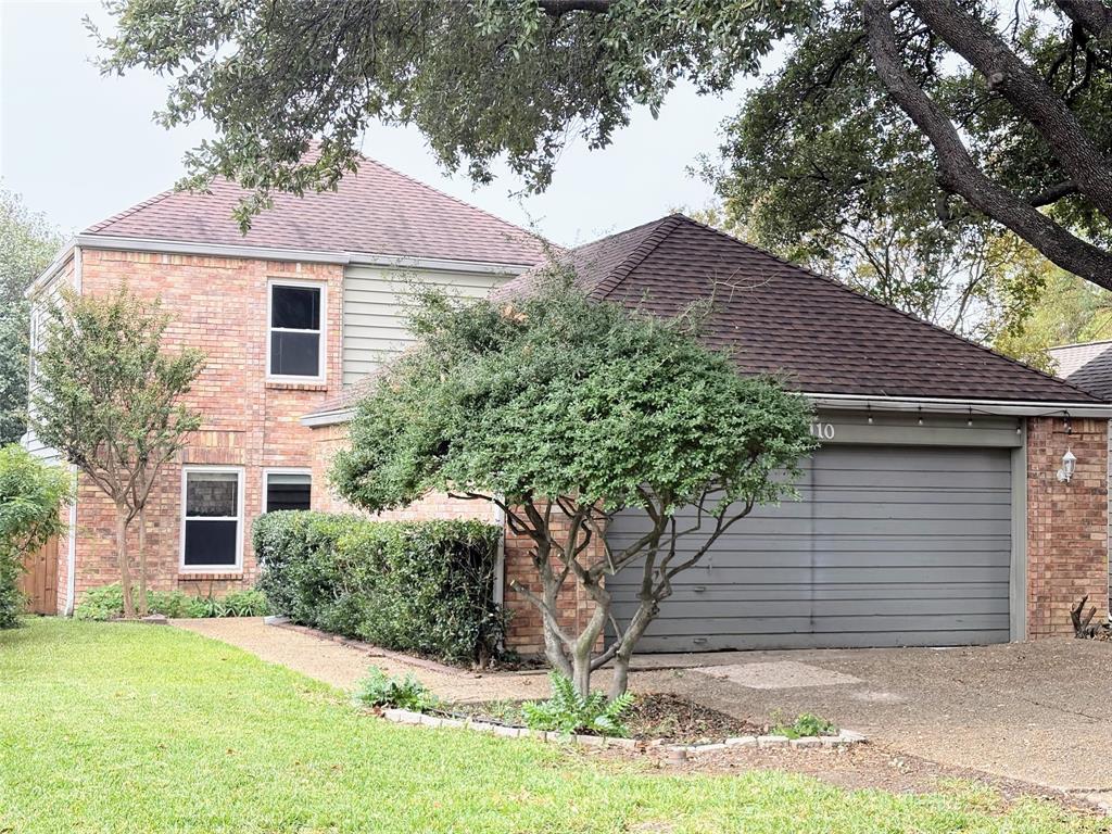 View of home's exterior with a garage and a lawn