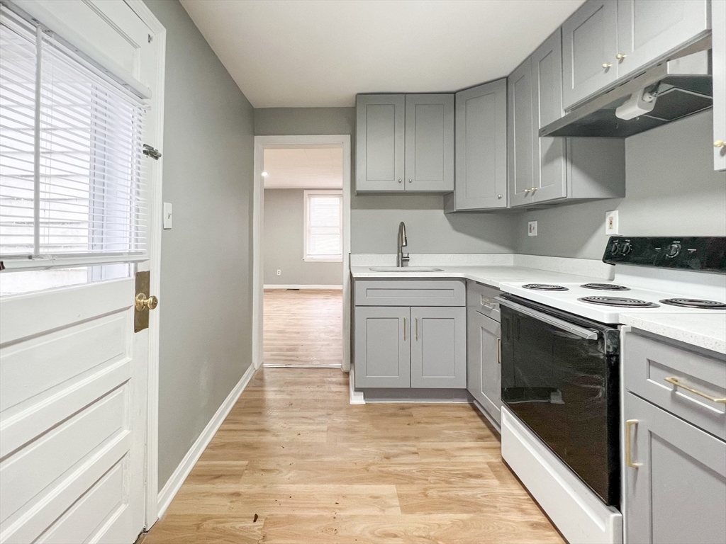 a kitchen with a sink stove and cabinets