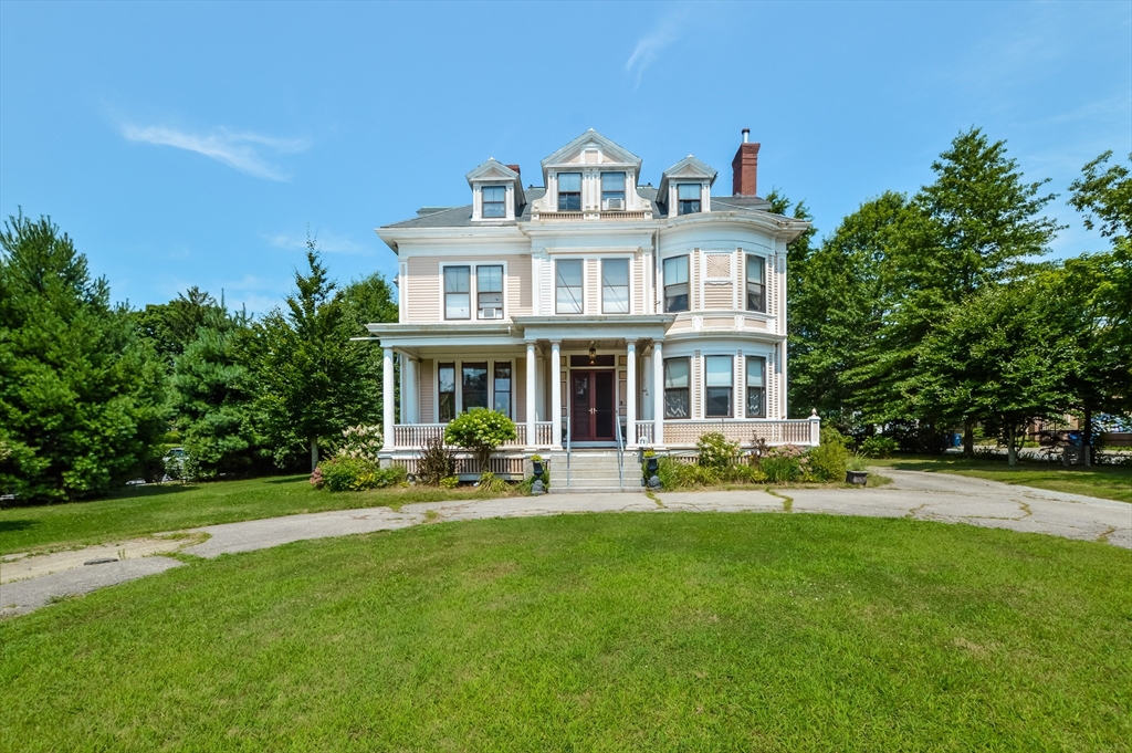 a front view of a house with a garden and porch