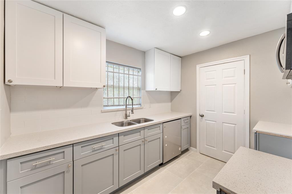 a kitchen with a sink and cabinets