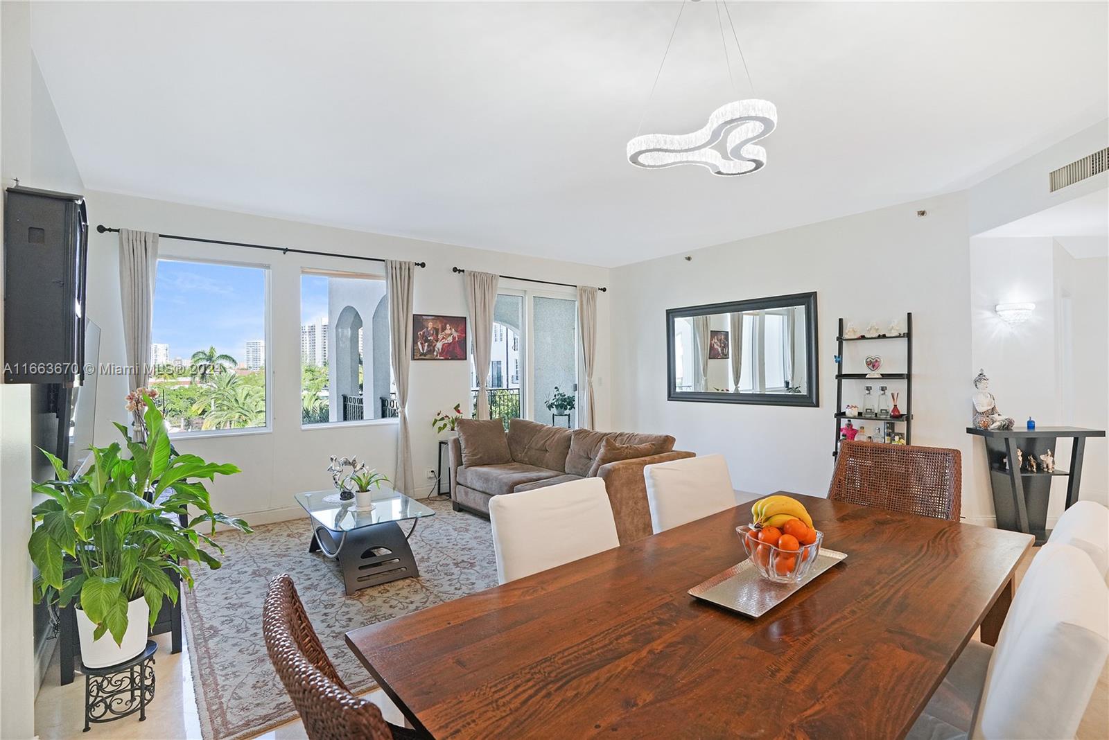 a living room with furniture kitchen and a table