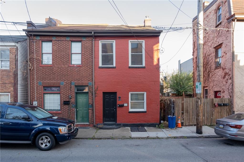 a car parked in front of a brick house