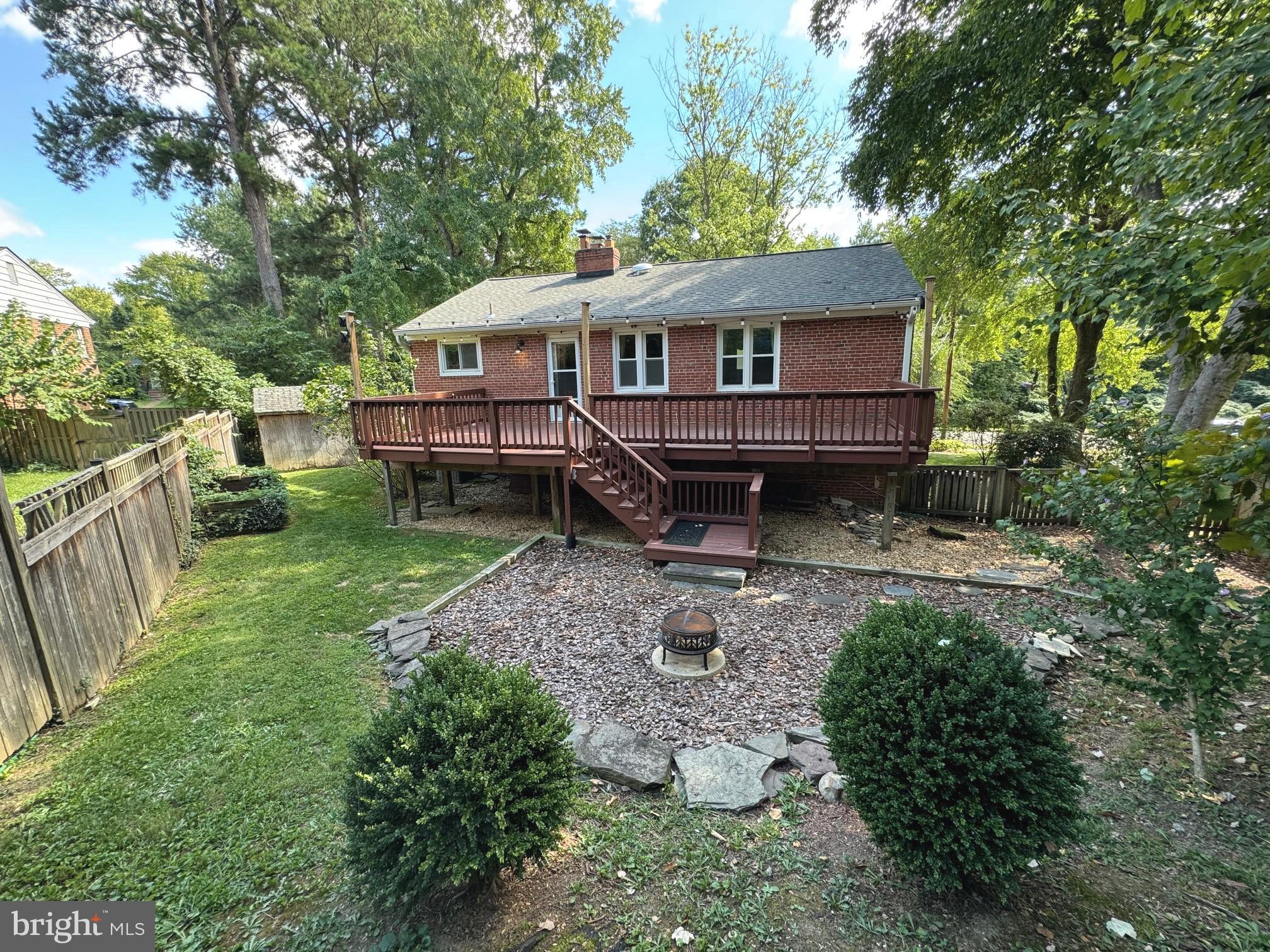 a front view of a house with a yard and deck