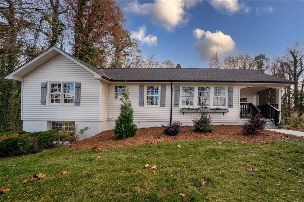 a view of a house with backyard and porch