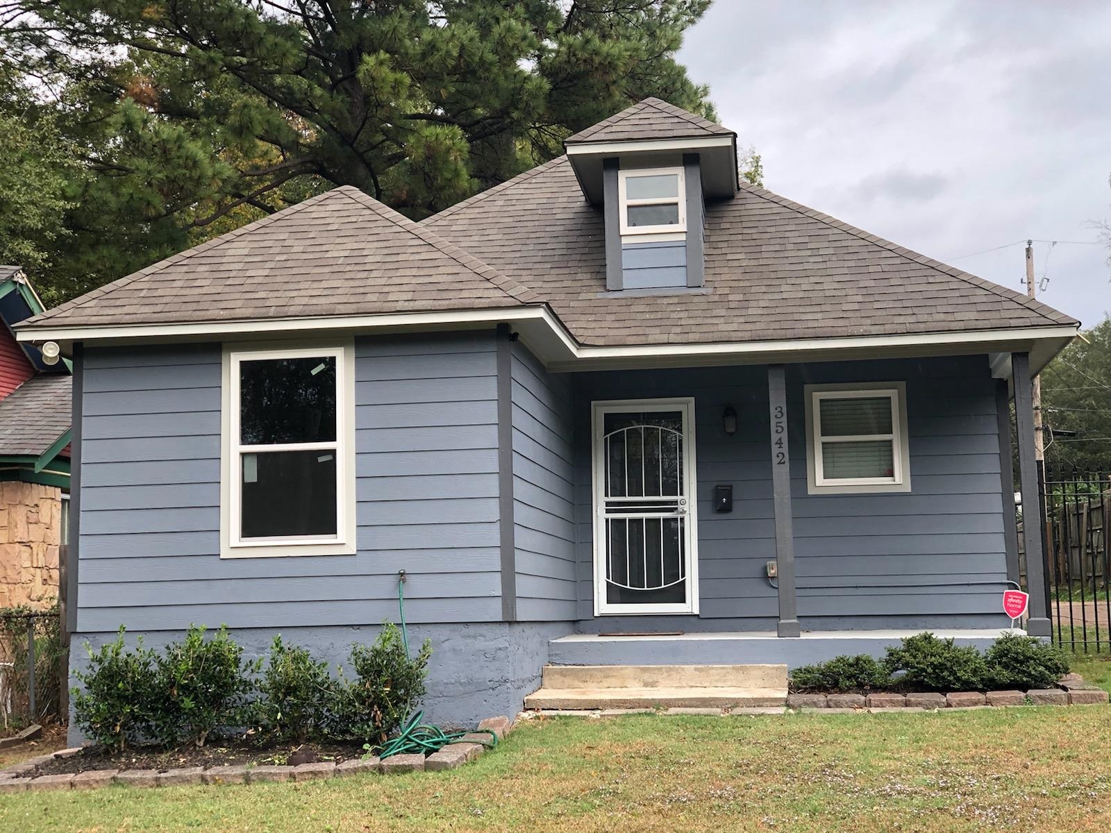 View of front of house with a front lawn and covered porch