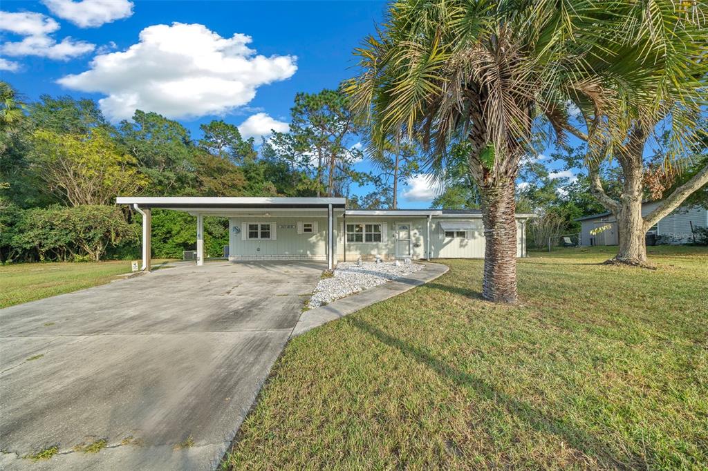 a front view of house with yard and green space