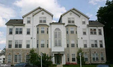 front view of a brick house with a and large windows