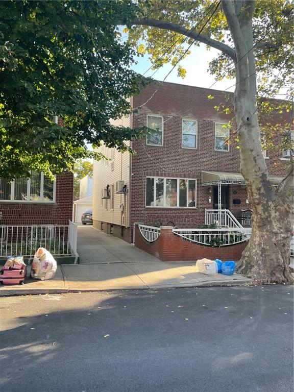 a front view of a house with a tree