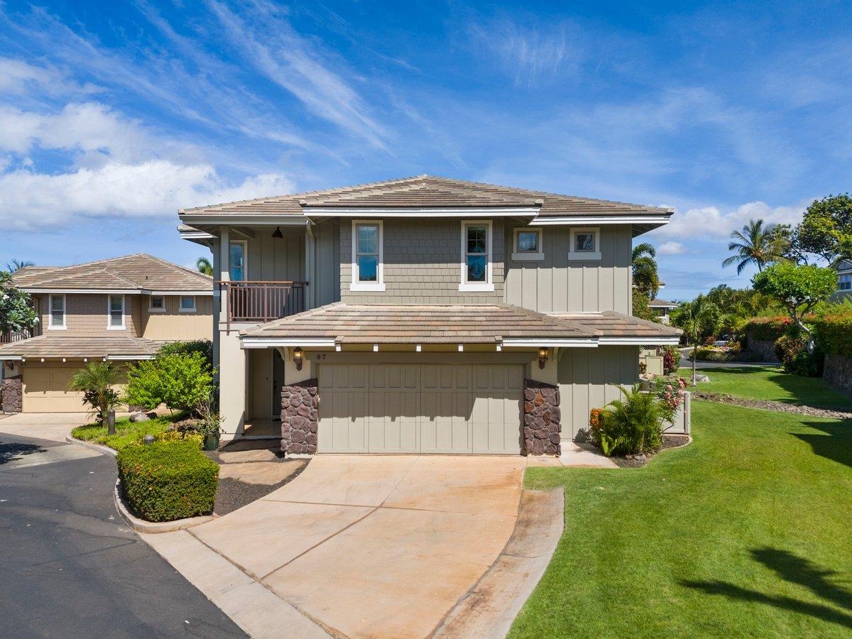 a front view of a house with a garden