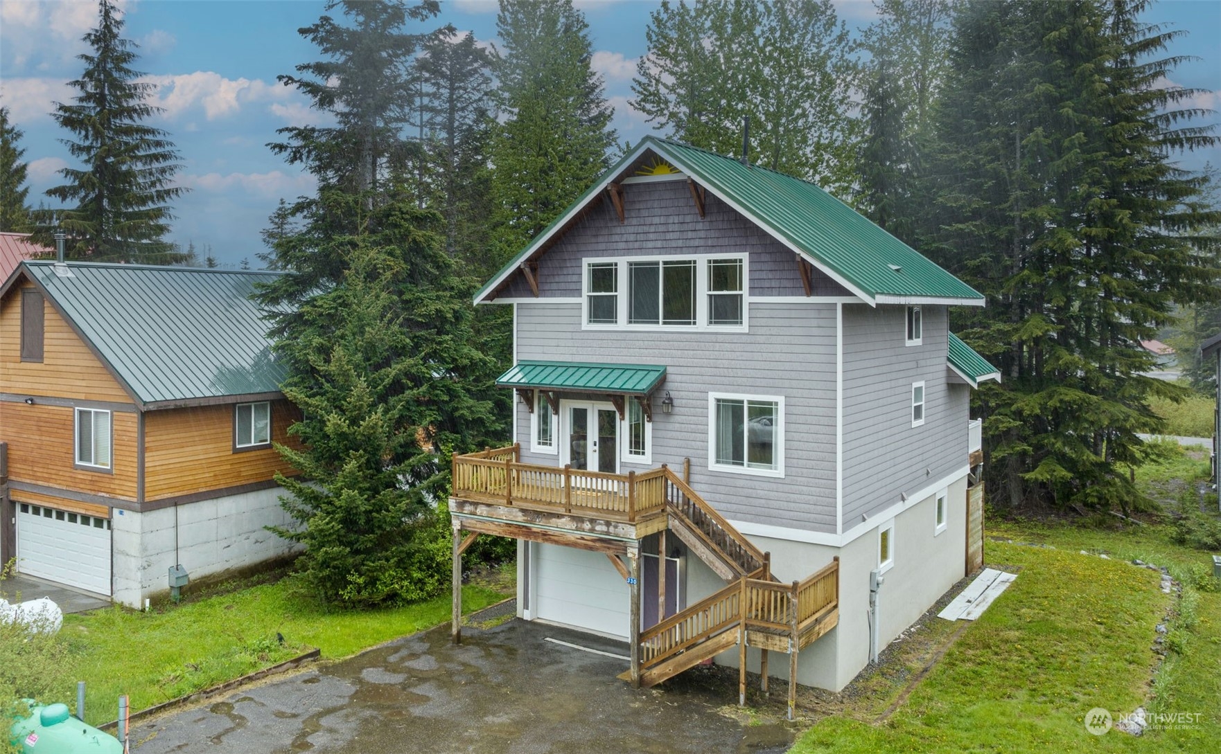 a view of a house with a yard and wooden fence