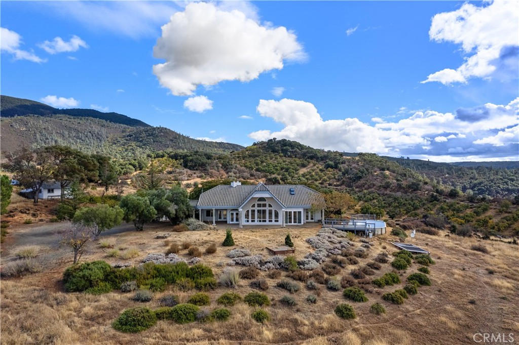 a view of a big house with a mountain