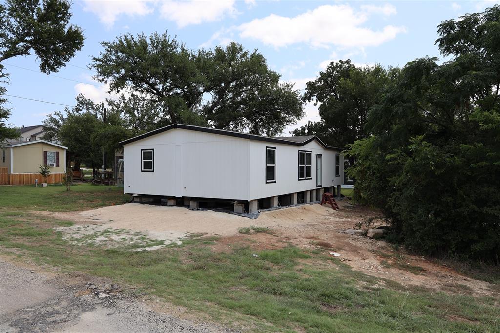 a view of house with backyard