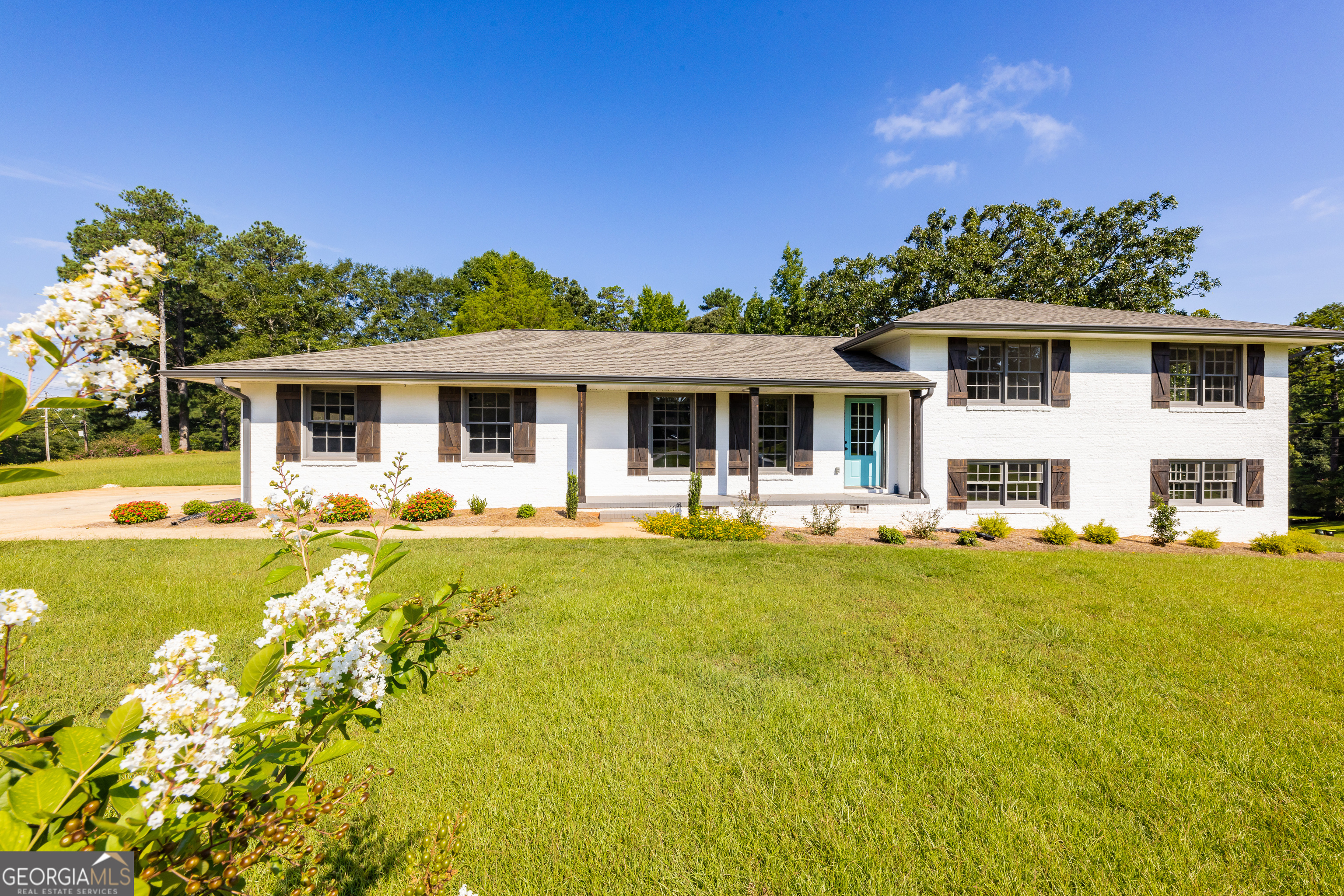 a front view of house with yard and swimming pool