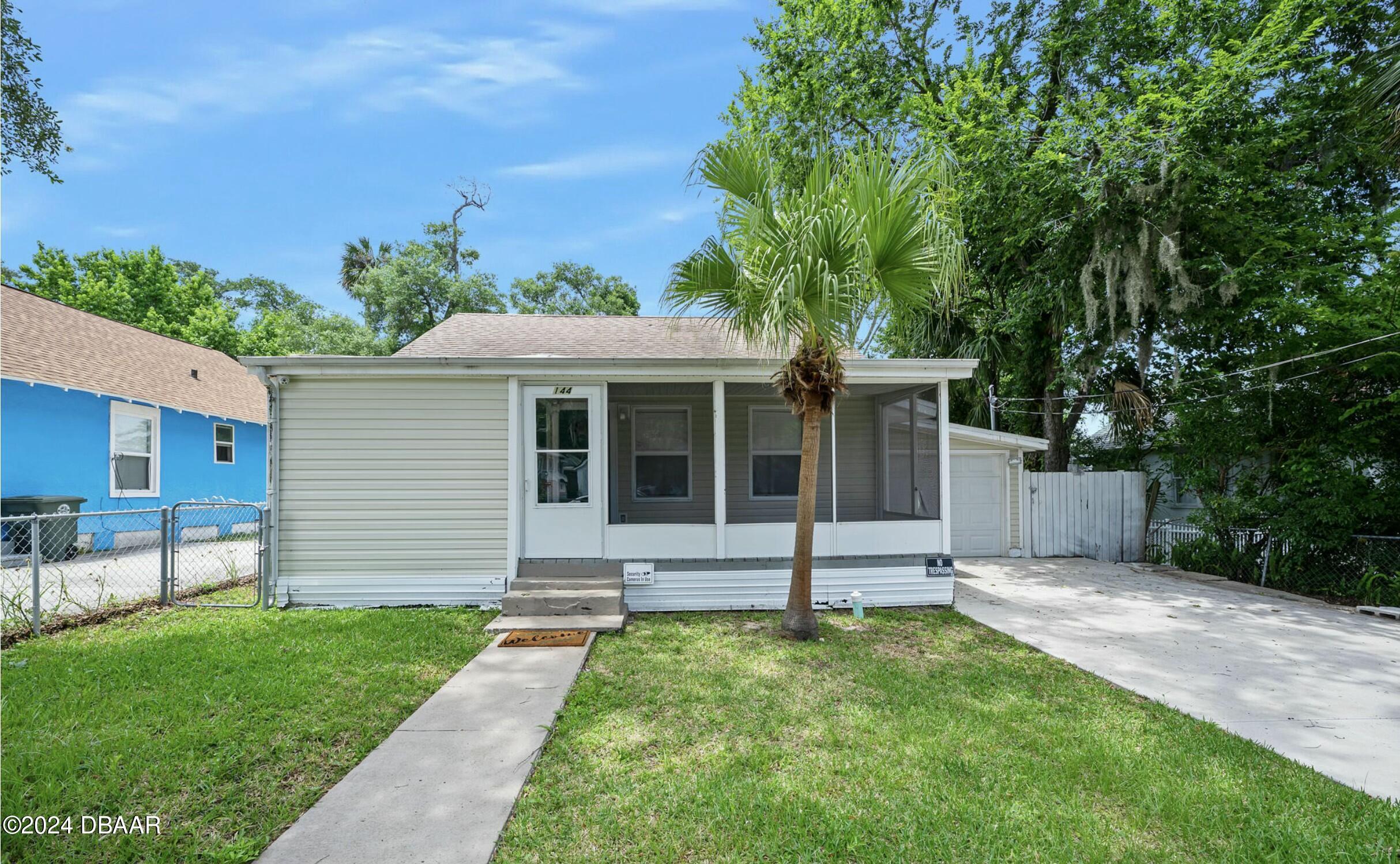 a view of a house with a yard and plants