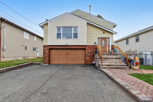 a view of a house with a parking area