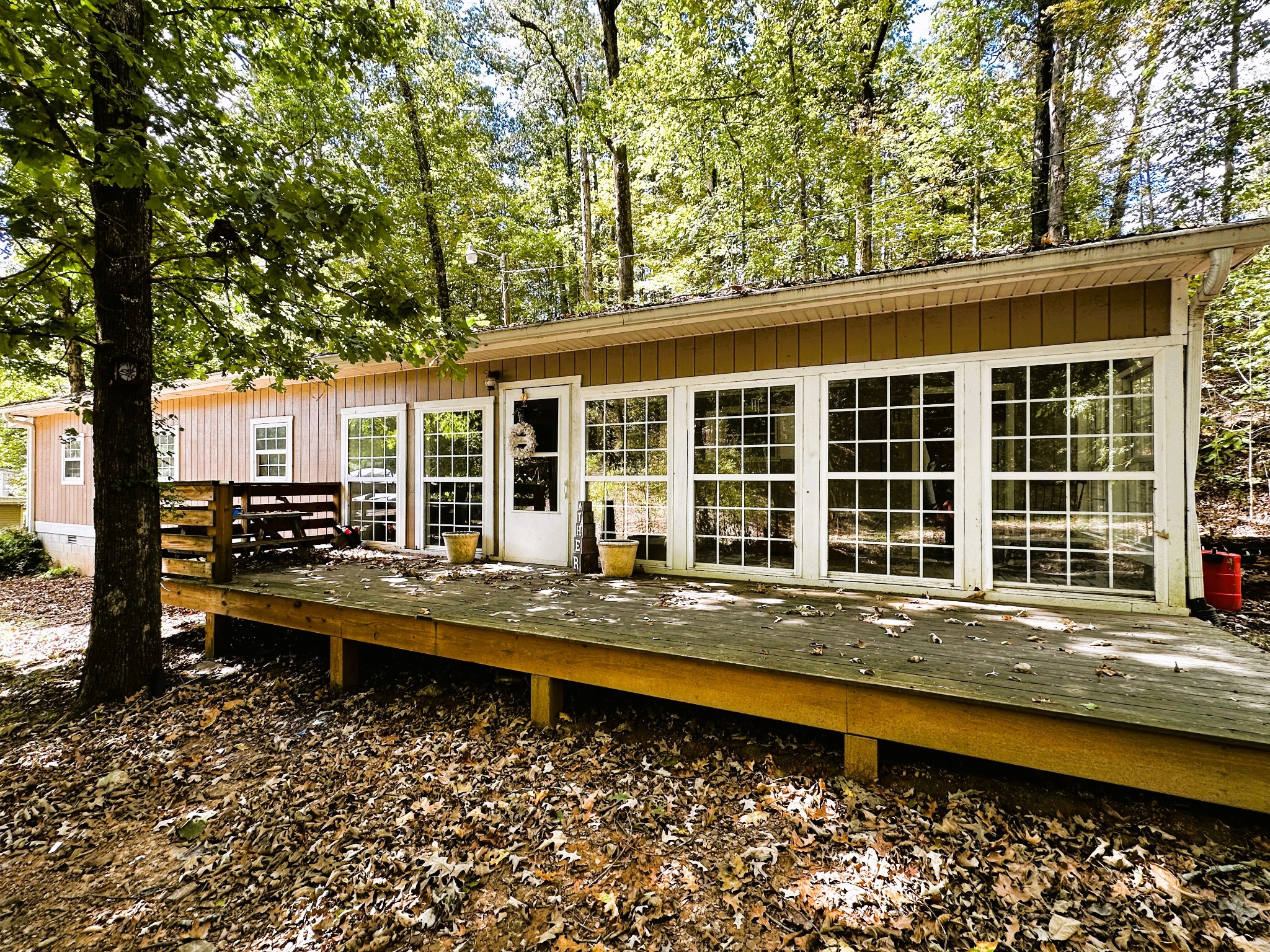 a front view of a house with swimming pool and sitting area