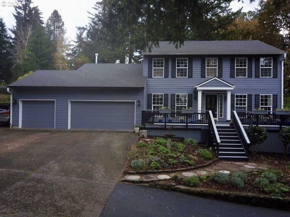 a front view of a house with a yard garage and outdoor seating