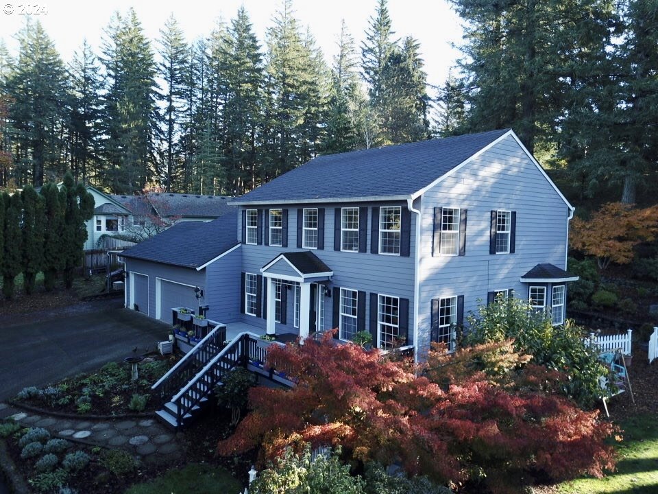 a front view of a house with a yard and trees