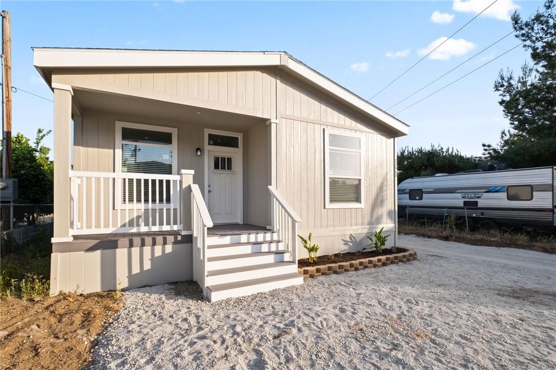 a view of a house with a small yard and wooden fence