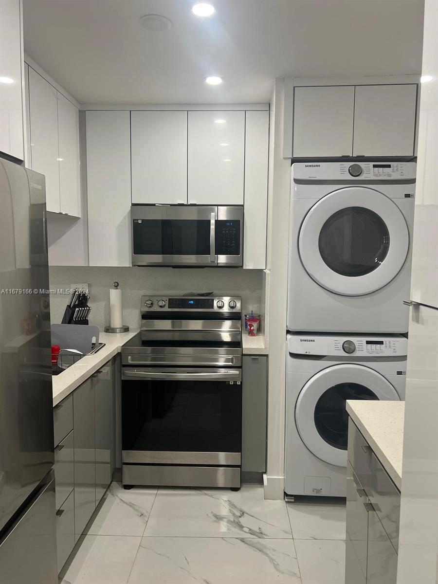 a kitchen with a stove top oven and cabinets