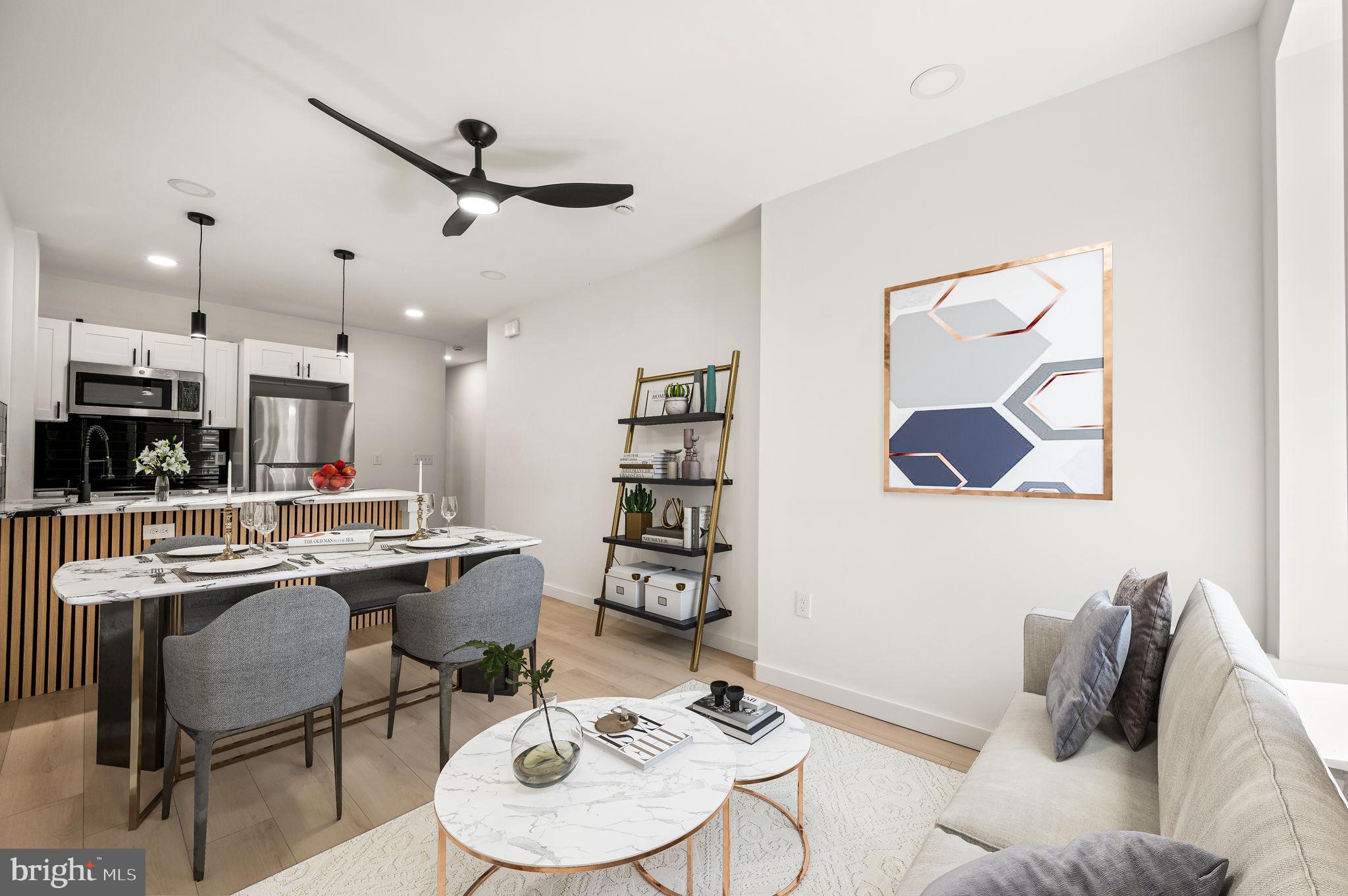 a living room with furniture and kitchen view