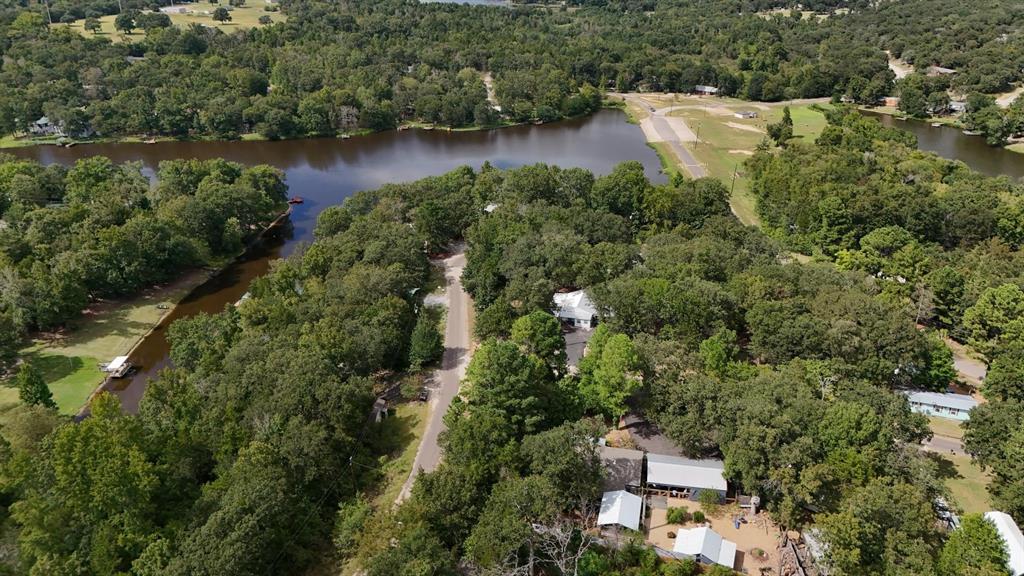 an aerial view of a house with a yard and lake view