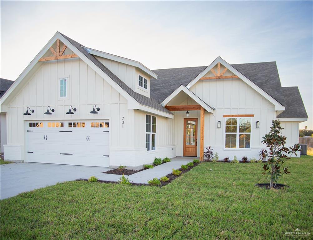 Modern inspired farmhouse featuring a front lawn