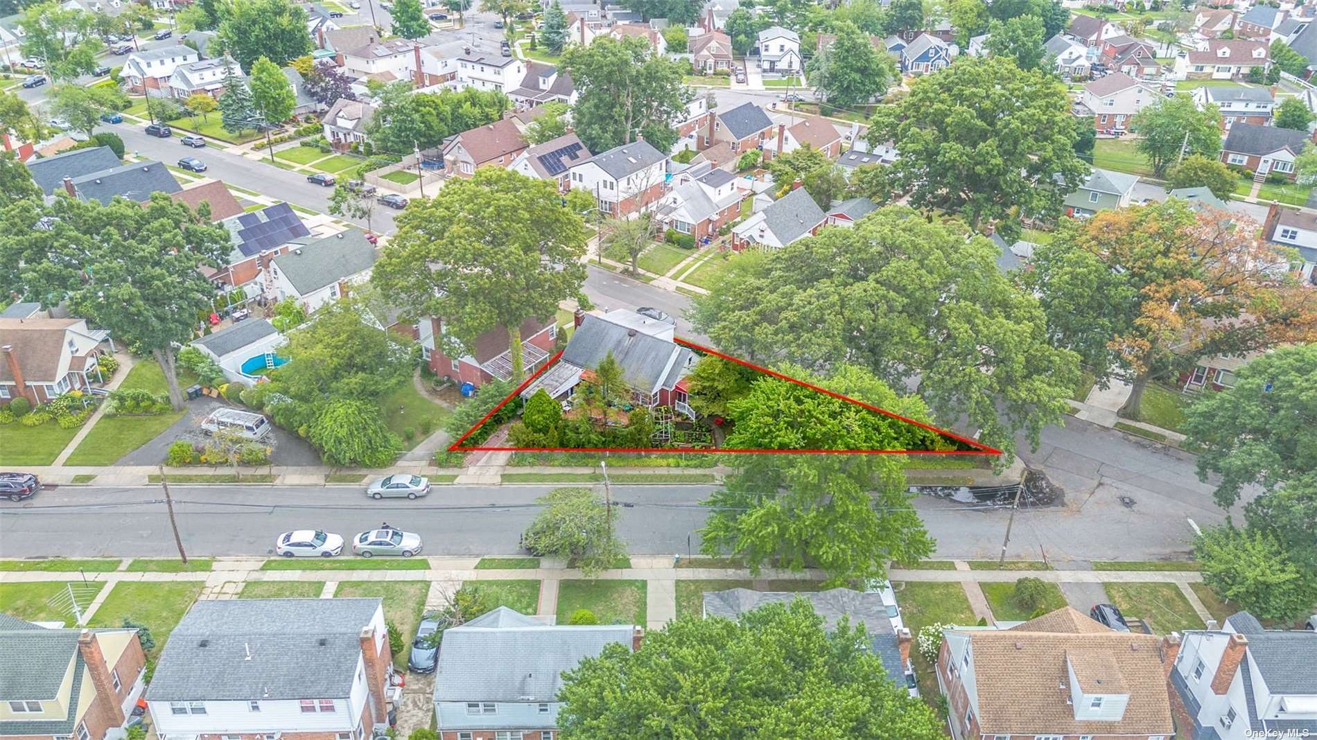 an aerial view of a house with a yard and potted plants