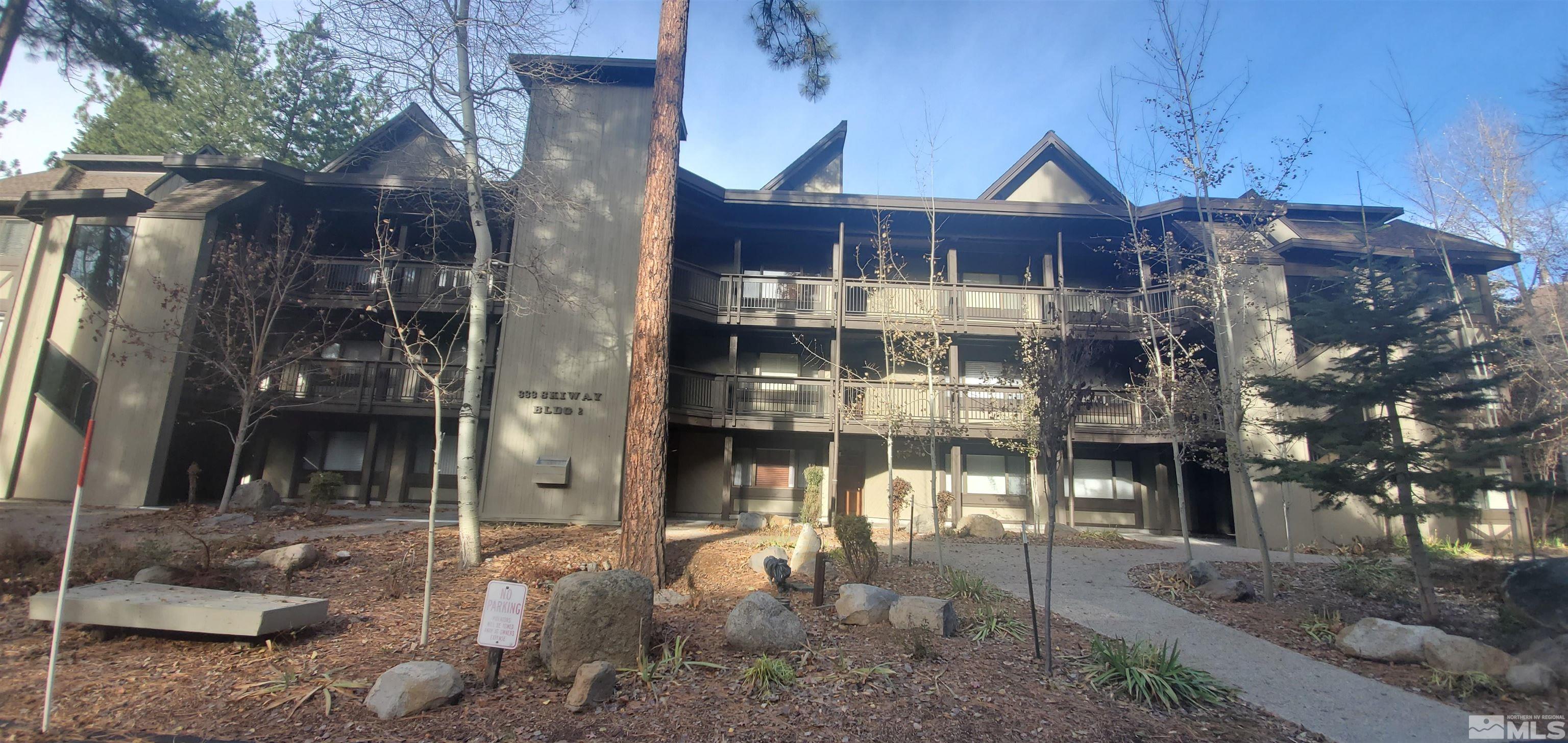 a front view of a residential apartment building with a yard