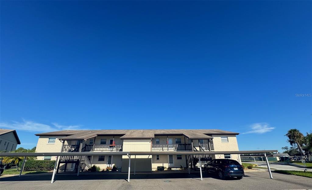 a view of a building with cars parked