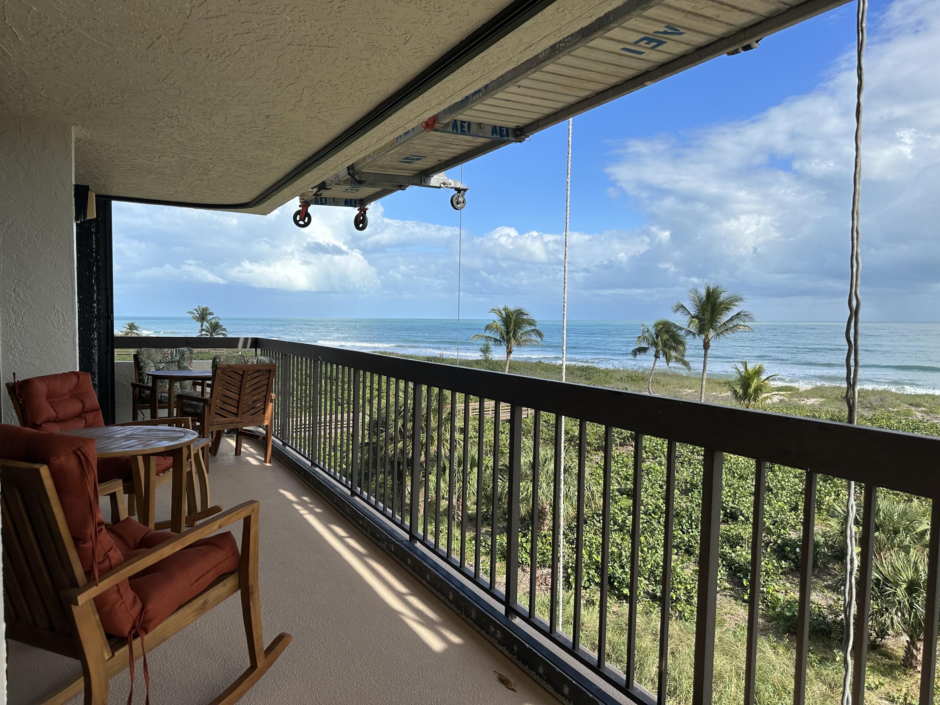 a view of a balcony with furniture