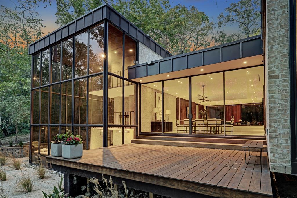 a view of balcony with wooden floor and iron fence