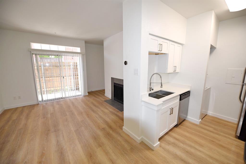 a kitchen with stainless steel appliances granite countertop a sink and a stove top oven