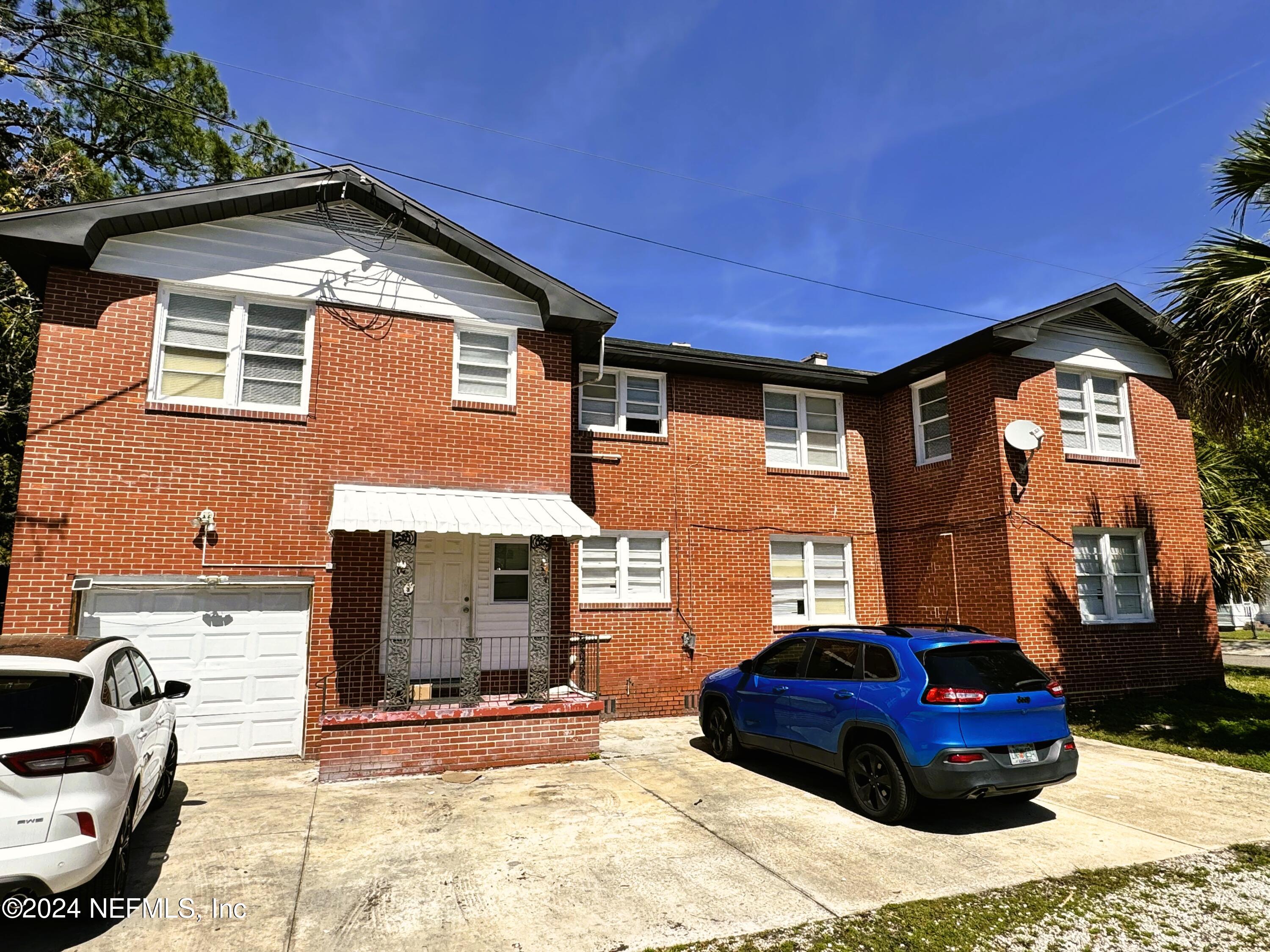 a front view of a house with parking space