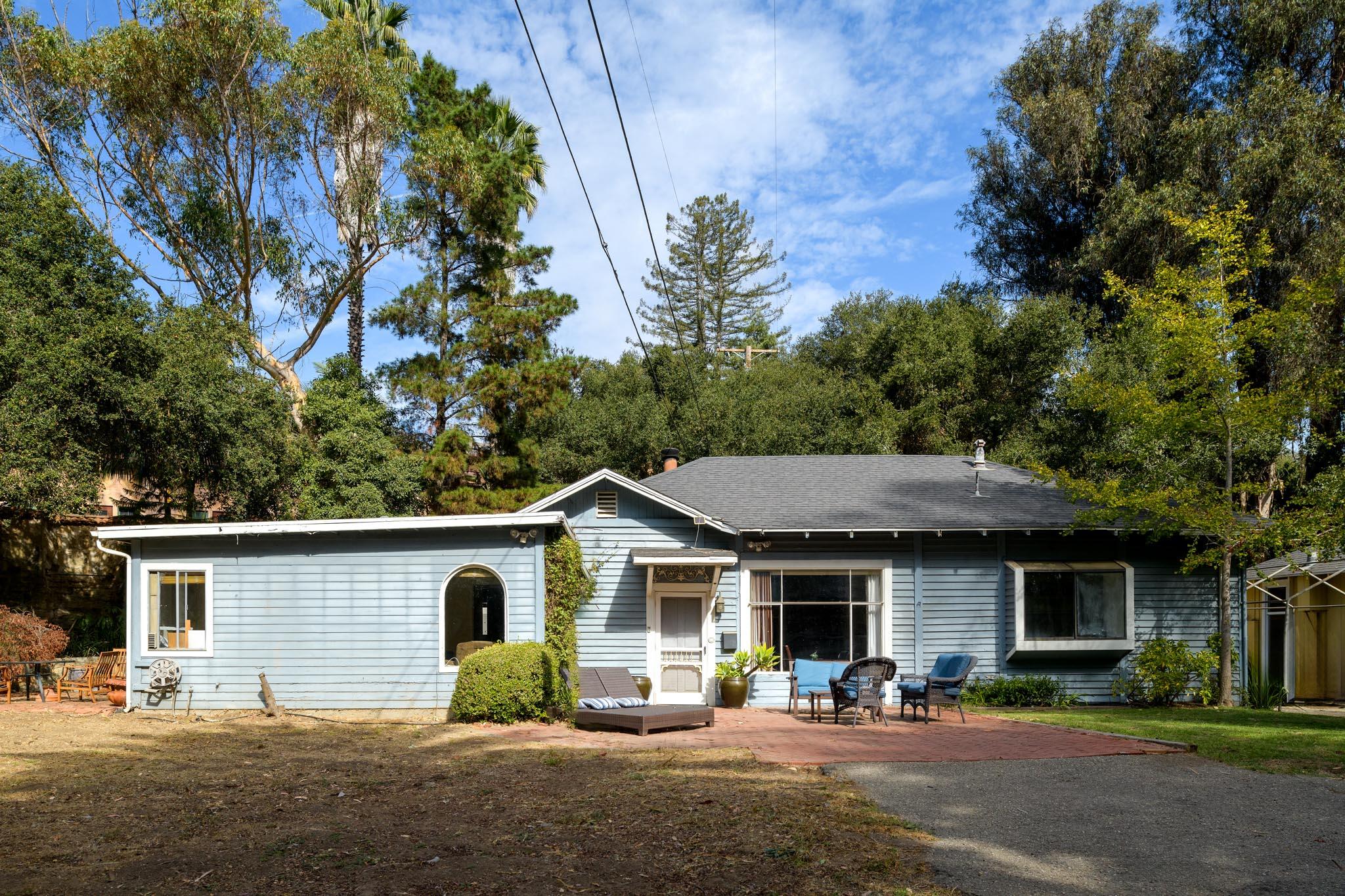 a front view of a house with garden and patio