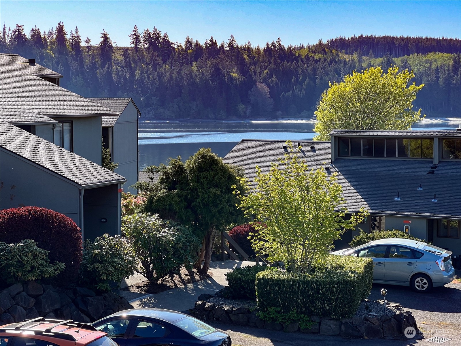 an aerial view of a house with garden space and a car parked on the road