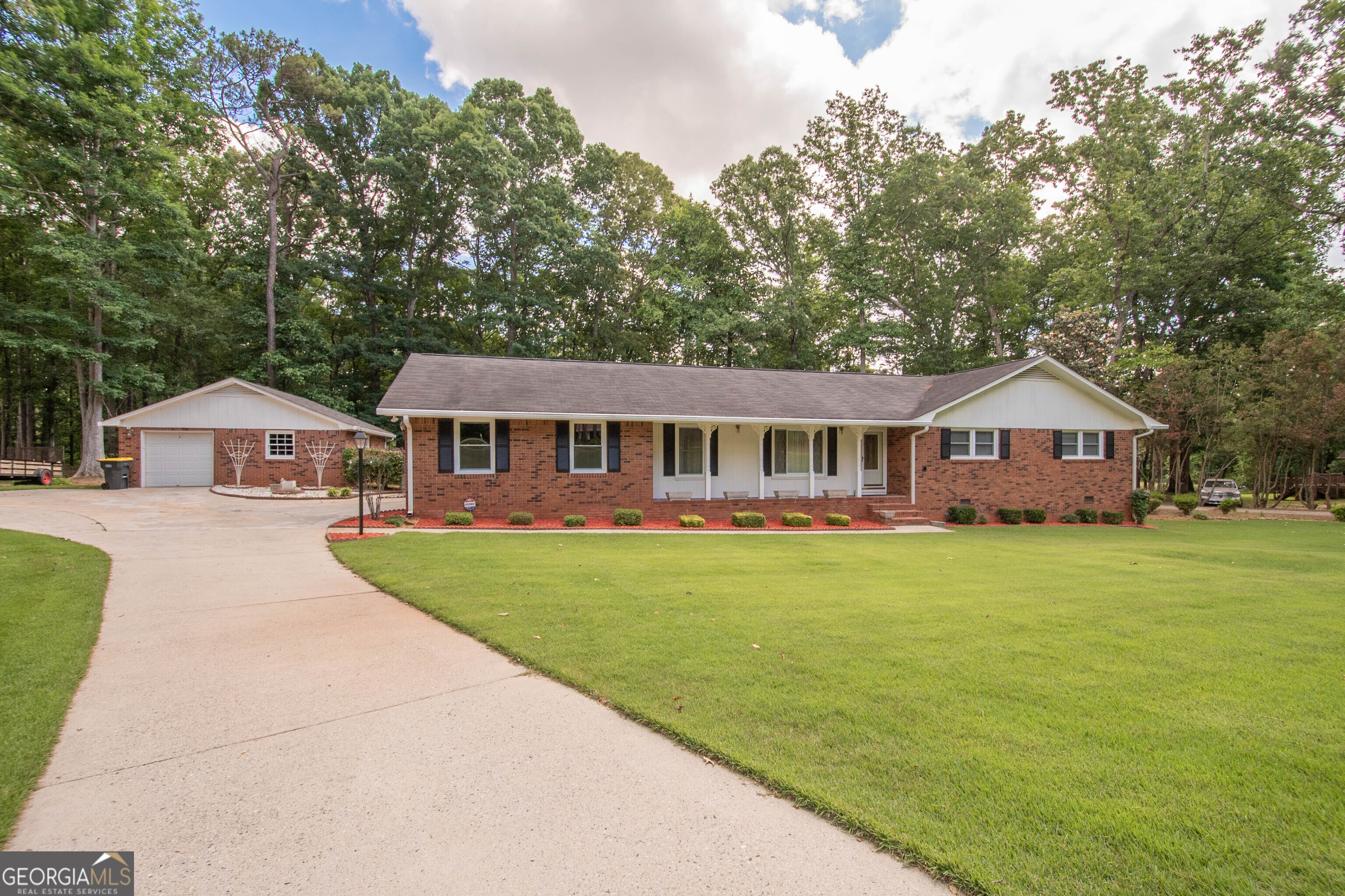 a front view of a house with garden