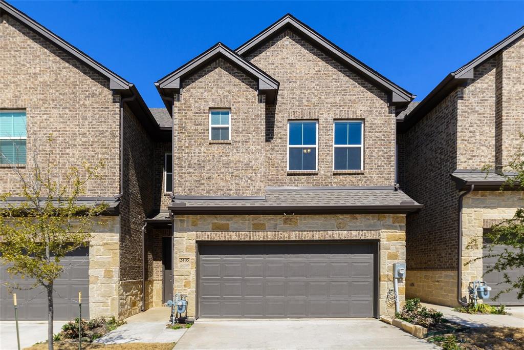 a front view of a house with a garage