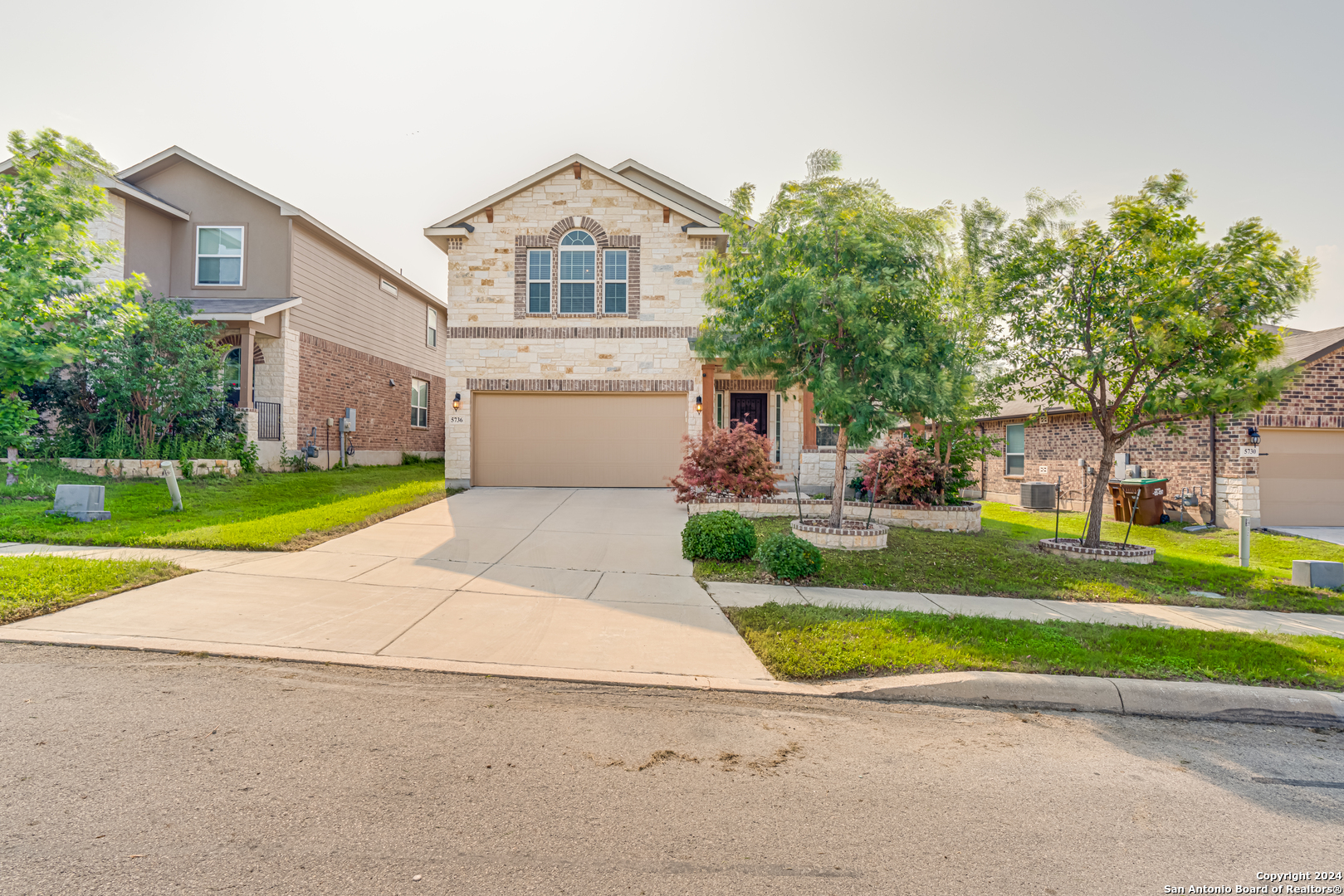 a front view of a house with a yard and garage