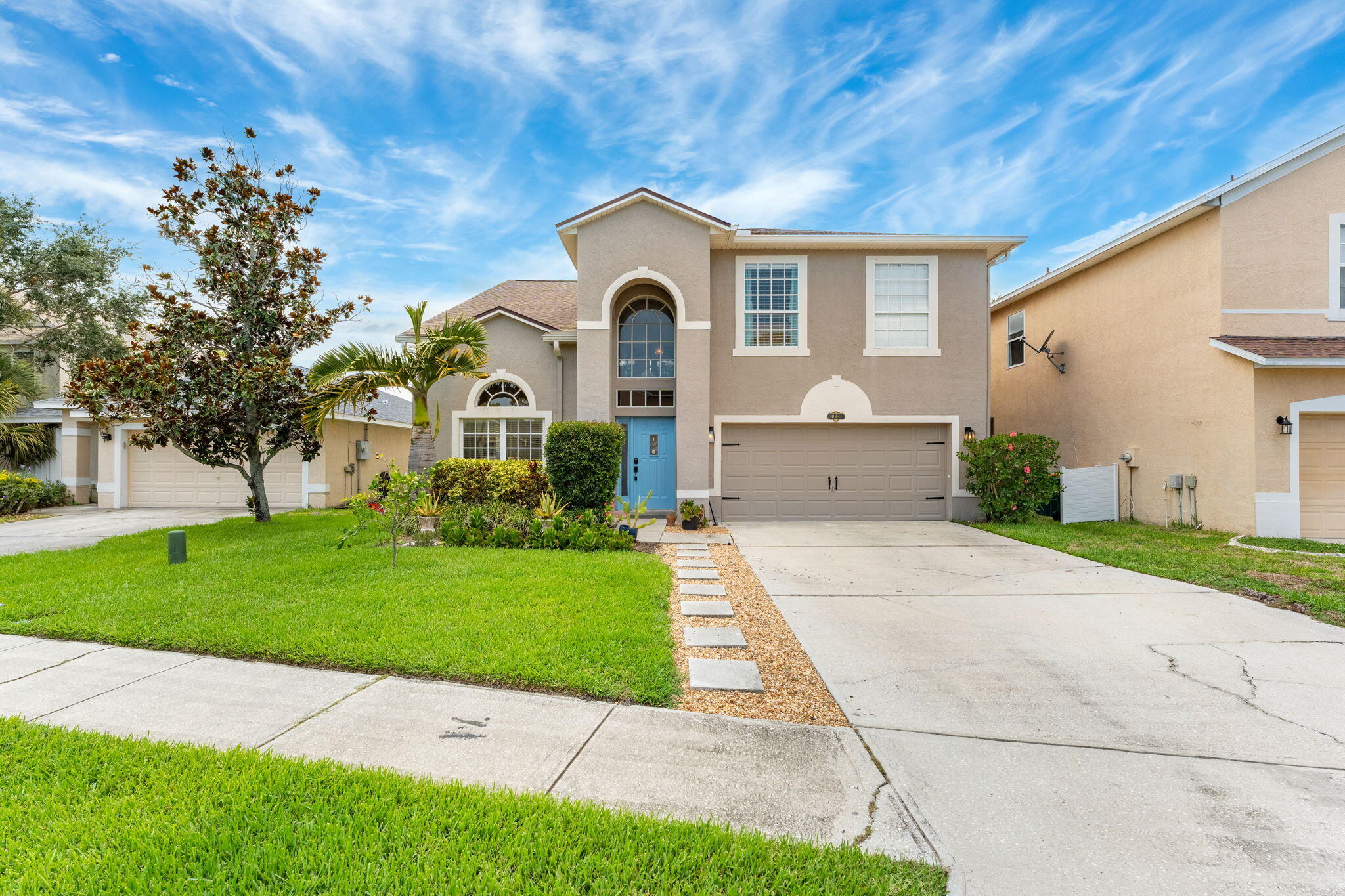 a front view of a house with garden