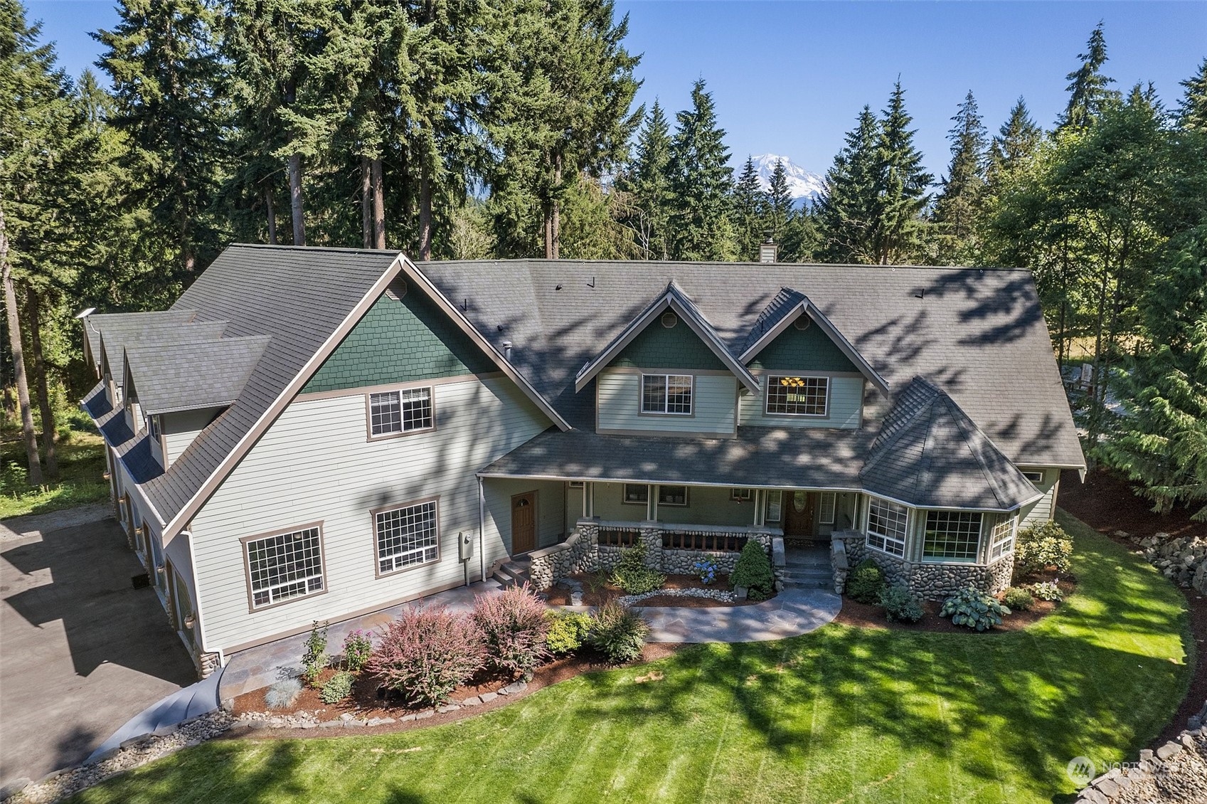 an aerial view of a house with a yard