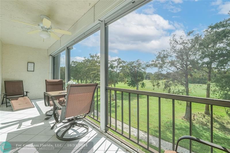 a view of a balcony with chair and wooden floor