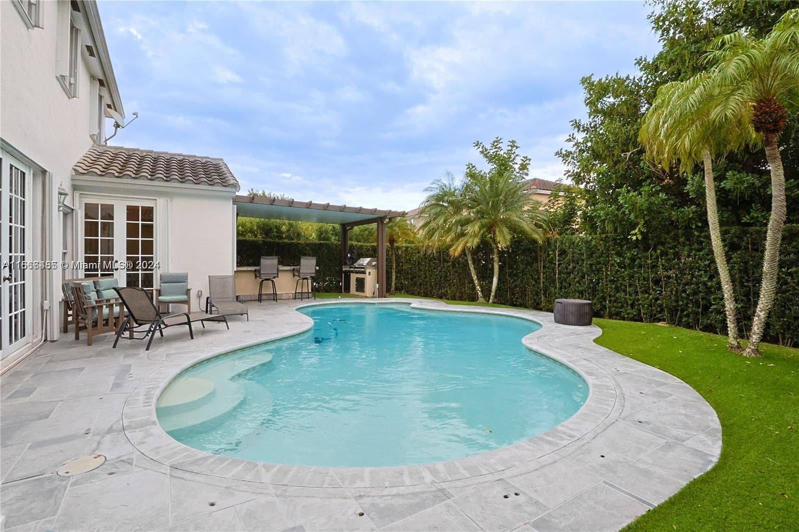 a view of a swimming pool with sitting area